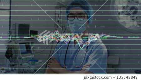 Standing doctor wearing scrubs and mask crossing arms in ICU, with stethoscope and ECG overlay 135548842