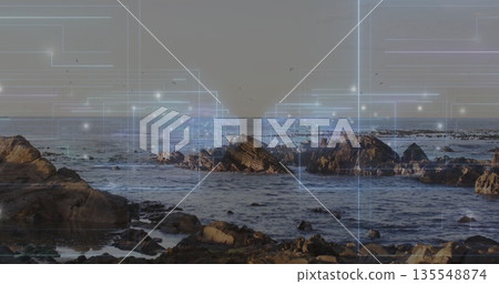Revealing jagged rock cluster rising from ocean water at shore, with glowing digital grid overlay Revealing jagged rock cluster rising from ocean water at shore, with glowing digital grid overlay 135548874