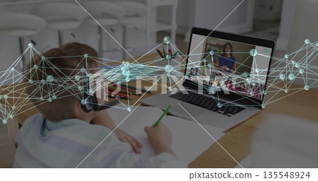 Sitting boy in shirt and headset at kitchen table, learning with laptop and pencils under overlay 135548924