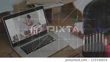 Child writing on paper with pencil while laptop in home study showing teacher wearing blazer, mug 135548934