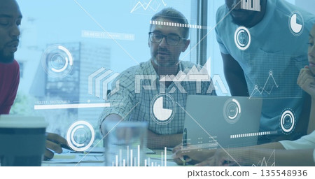 Reviewing data mature male with glasses typing on laptop at meeting desk, with documents and charts Reviewing data mature male with glasses typing on laptop at meeting desk, with documents and charts 135548936