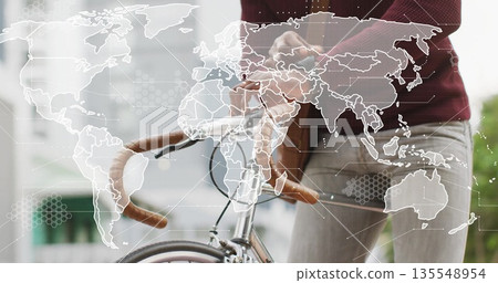 Gripping drop handlebars Black man wearing burgundy sweater standing on sidewalk, world map overlay 135548954