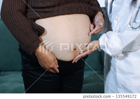 cropped shot of doctor examining pregnant woman during medical consultation 135549172
