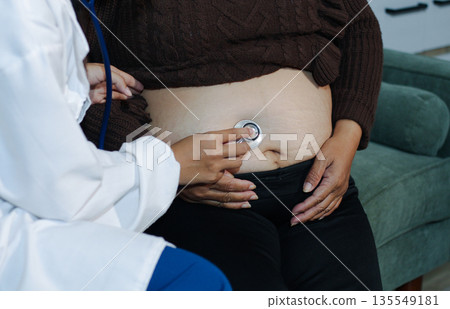 cropped shot of doctor examining pregnant woman during medical consultation cropped shot of doctor examining pregnant woman during medical consultation 135549181