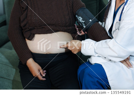 cropped shot of doctor examining pregnant woman during medical consultation cropped shot of doctor examining pregnant woman during medical consultation 135549191