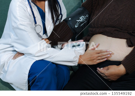 cropped shot of doctor examining pregnant woman during medical consultation cropped shot of doctor examining pregnant woman during medical consultation 135549192