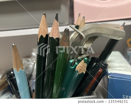 Close-up of work tools and writing implements in a pen holder Close-up of work tools and writing implements in a pen holder 135549231