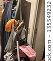 A messy entrance and room that reflects a busy everyday life 135549232