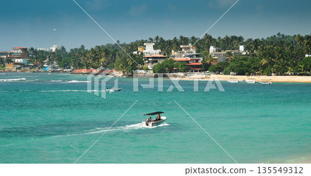 Dynamic Coastal View with Boats and Lush Greenery Nearby 135549312