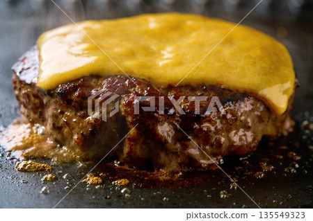 Making cheese burger in a grill, selective focus. Making cheese burger in a grill, selective focus. 135549323