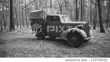 German Vehicle Truck Opel Blitz In Forest. Sunny Autumn Day. Military Truck Opel. German Wehrmacht World War Ii Military Automotive. Autumn Season Nature. Reenactment Tactic Game. Black And White 135549393