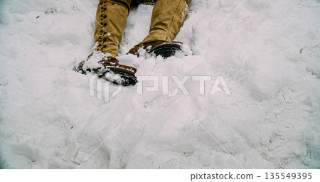 Close-up View On Army Boots Of Re-enactor Dressed As American Infantry Soldier. Fallen Soldier Of United States Army Infantry At World War Ii. Heroes Of War. Military Boots Of Dead Soldier On Snow 135549395