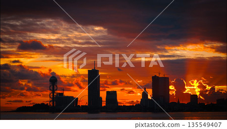 Batumi, Adjara, Georgia. View From Sea Beach To Cityscape With Modern Urban Architecture, Skyscrapers And Tower. Embankment At Sunset Sunrise. Bright Evening Sky In Yellow, Orange And Red Colors 135549407