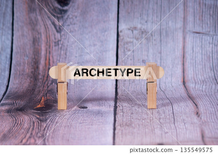 Archetype symbol. Single Wooden stick supported by Clothespins, beautiful Light Orange tone highlight Wooden Texture Background. Business and Archetype concept with copy space 135549575