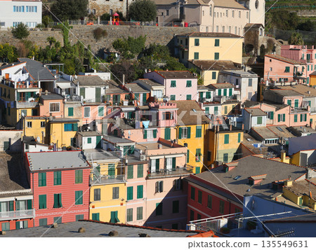 View of Vernazza, a town in Cinque Terre, from the mountain. Nature and sea, traditional buildings of Liguria, Italy. Architecture protected by UNESCO. Church of Santa Margherita. 135549631