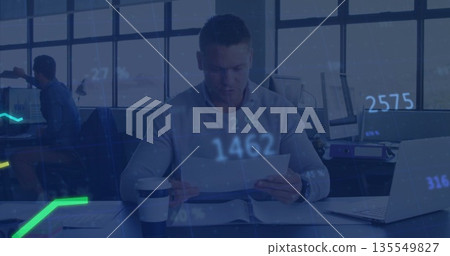 Reviewing adult man in shirt examining documents at modern office, with coffee and financial charts Reviewing adult man in shirt examining documents at modern office, with coffee and financial charts 135549827