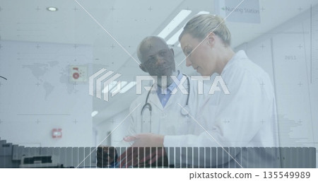 Two doctors examining test tube rack in hospital corridor near nursing station, with stethoscope 135549989
