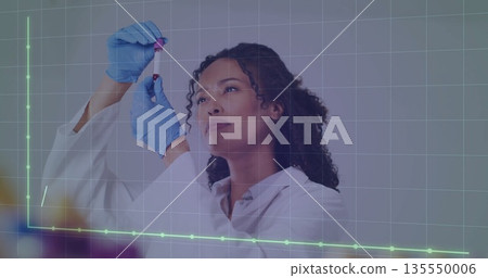 Analyzing red liquid in laboratory, mid adult technician holding test tube with gloves and coat Analyzing red liquid in laboratory, mid adult technician holding test tube with gloves and coat 135550006