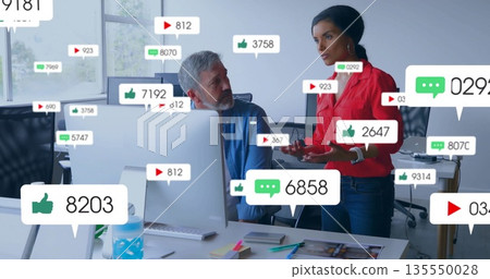 Woman in red blouse discussing social media at workspace with colleague, with icons, copy space Woman in red blouse discussing social media at workspace with colleague, with icons, copy space 135550028