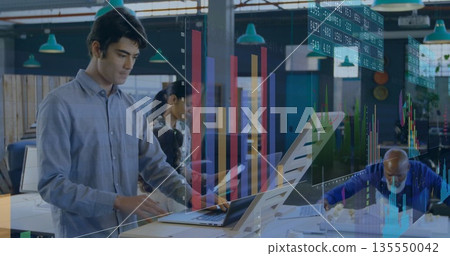Native-American analyst typing on laptop at standing desk in office, showing charts, copy space Native-American analyst typing on laptop at standing desk in office, showing charts, copy space 135550042