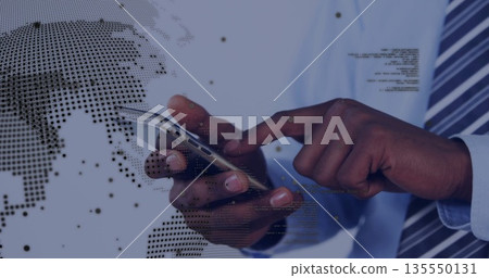 Tapping office worker wearing tie interacting with smartphone in office, world map and code overlay Tapping office worker wearing tie interacting with smartphone in office, world map and code overlay 135550131
