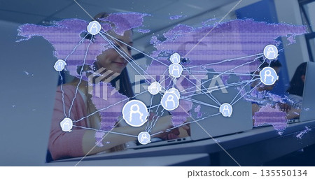 Typing teenage female student in pink cardigan using laptop in computer lab, global network overlay Typing teenage female student in pink cardigan using laptop in computer lab, global network overlay 135550134