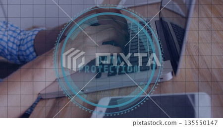 Typing worker wearing blue shirt using laptop on wooden desk with data protection grid hud overlay Typing worker wearing blue shirt using laptop on wooden desk with data protection grid hud overlay 135550147