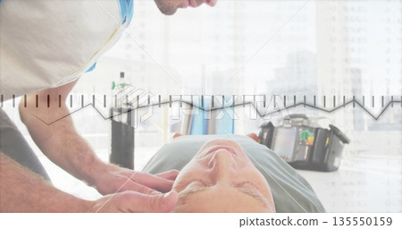 Supporting patient neck, therapist manipulating spine on therapy table in clinic, with monitor unit Supporting patient neck, therapist manipulating spine on therapy table in clinic, with monitor unit 135550159
