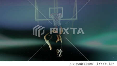 Standing basketball player raising ball at free-throw line in hazy arena, with hoop, net, jersey 22 Standing basketball player raising ball at free-throw line in hazy arena, with hoop, net, jersey 22 135550187
