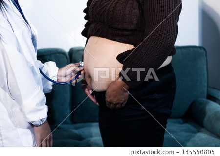 cropped shot of doctor examining pregnant woman during medical consultation 135550805