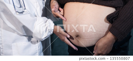 cropped shot of doctor examining pregnant woman during medical consultation cropped shot of doctor examining pregnant woman during medical consultation 135550807