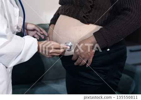 cropped shot of doctor examining pregnant woman during medical consultation cropped shot of doctor examining pregnant woman during medical consultation 135550811