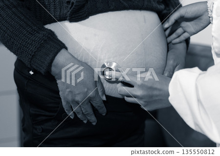 cropped shot of doctor examining pregnant woman during medical consultation cropped shot of doctor examining pregnant woman during medical consultation 135550812