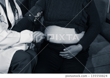 cropped shot of doctor examining pregnant woman during medical consultation cropped shot of doctor examining pregnant woman during medical consultation 135550824