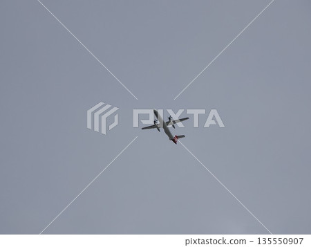 Wings cutting through the cloudy sky - A propeller plane flying over Sydney Park 135550907
