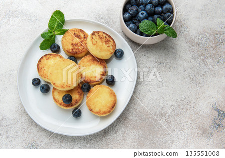 Syrniki cottage cheese pancakes with blueberries and mint Syrniki cottage cheese pancakes with blueberries and mint 135551008