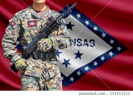 Arkansas US state flag with soldier holding assault rifle 135551552