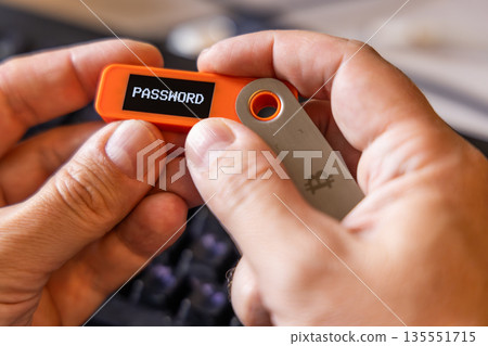 hardware Bitcoin wallet in a hands with password message on screen hardware Bitcoin wallet in a hands with password message on screen 135551715