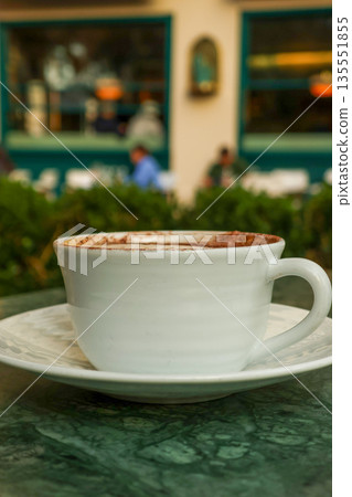 Coffee cup on green marble table enjoying Parisian cafe atmosphere 135551855