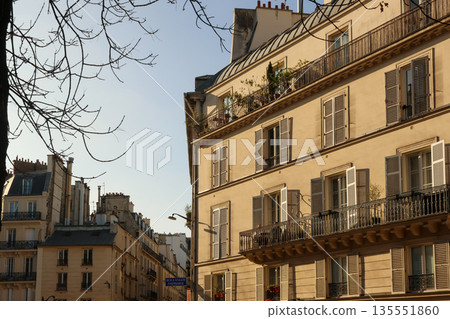 Parisian Haussmann architecture with balconies and open shutters on an urban street. Paris, France Parisian Haussmann architecture with balconies and open shutters on an urban street. Paris, France 135551860