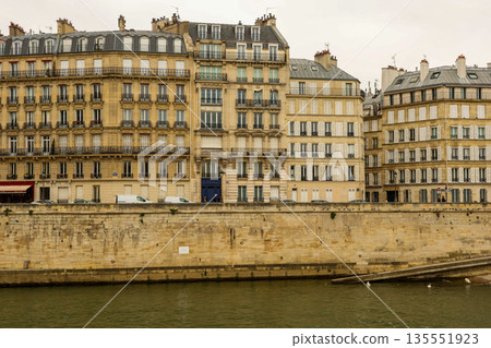 Classical Haussmann apartment buildings lining the Seine River in Paris, France Classical Haussmann apartment buildings lining the Seine River in Paris, France 135551923