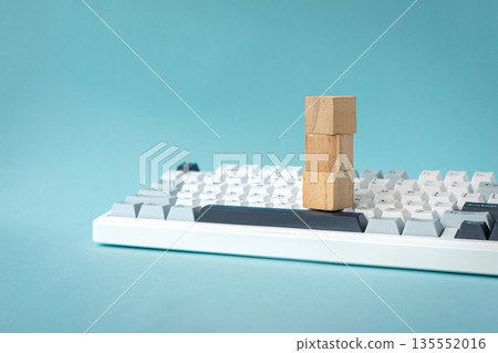 3 blank square wood blocks on top of keyboard. 3 blank square wood blocks on top of keyboard. 135552016