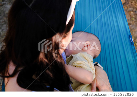 Mother and Baby Relaxing on a Hammock 135552026