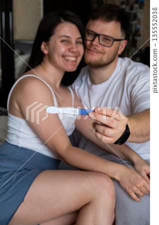 Happy Couple Celebrating Positive Pregnancy Test 135552038