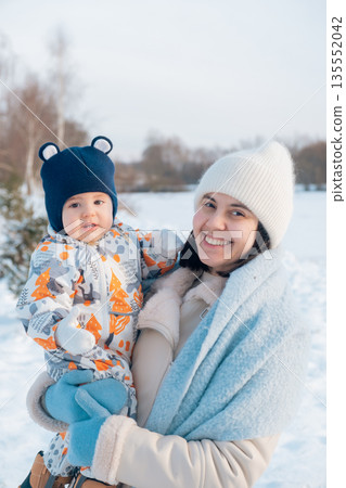 Mother and Baby Enjoying a Winter Day 135552042