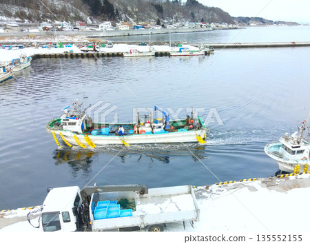 Aerial view of fishing boats entering Ishikura Fishing Port in Mori Town, Hokkaido in winter 135552155