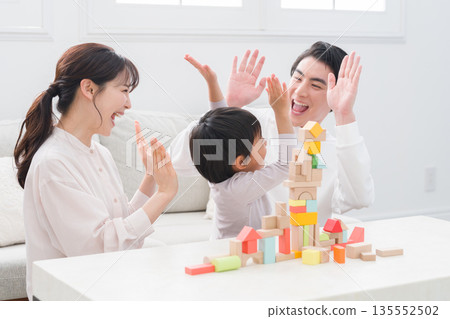 Family playing with building block toys 135552502