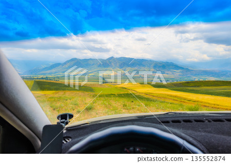 rural landscape behind car windshield, drivers perspective rural landscape behind car windshield, drivers perspective 135552874