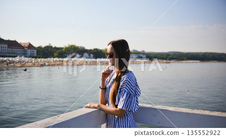 Woman looking at the sea on a sunny day in Sopot, Poland Woman looking at the sea on a sunny day in Sopot, Poland 135552922