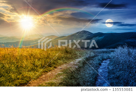 dirt road through grassy meadow on ridge. time change concept. beautiful summer landscape in green mountains under cloudy sky with sun and moon. uncertainty, trust issues and difficult relationship dirt road through grassy meadow on ridge. time change concept. beautiful summer landscape in green mountains under cloudy sky with sun and moon. uncertainty, trust issues and difficult relationship 135553081